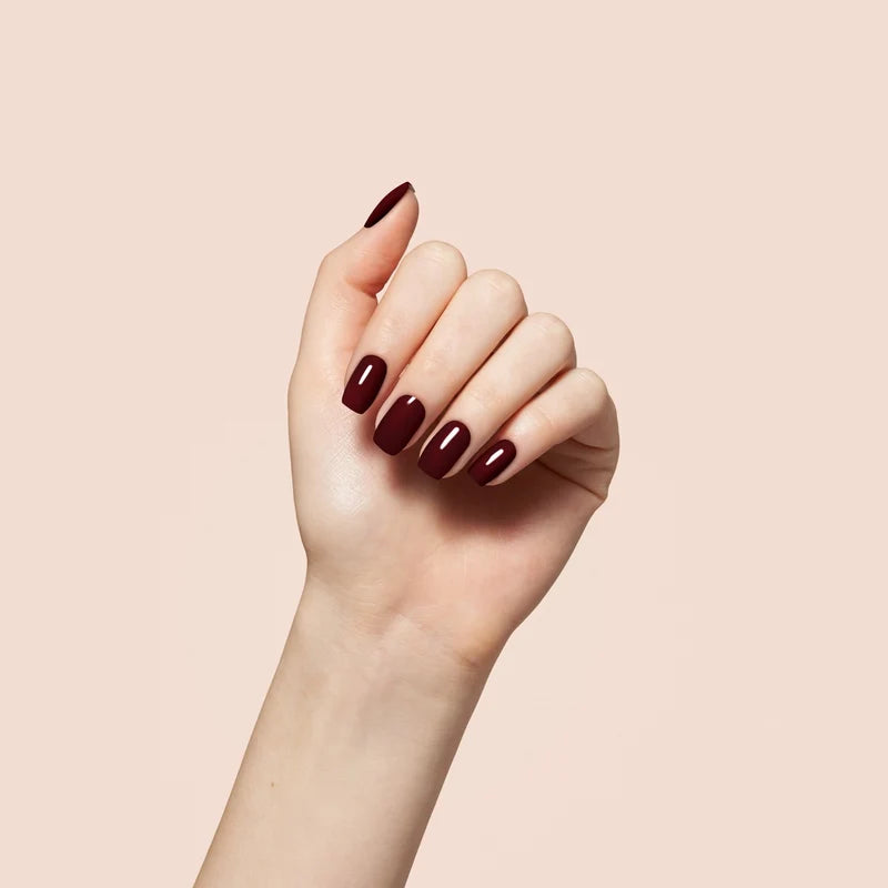 Full manicure in Bio Seaweed Gel 1022 Another Merlot on a hand, highlighting the deep wine red color on all nails.
