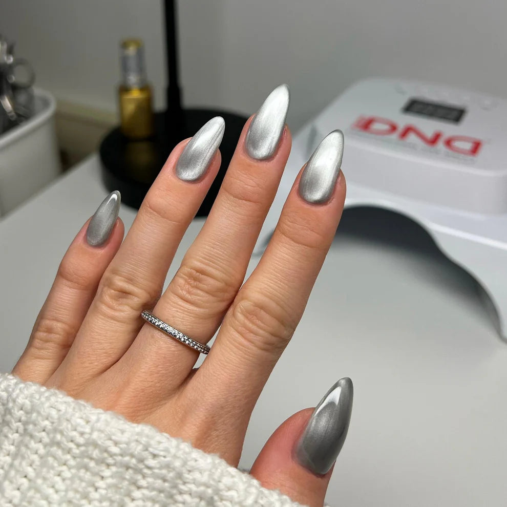 Close-up of cat eye nail effect showing luminous silver magnetic stripe created with DND Diva gel polish