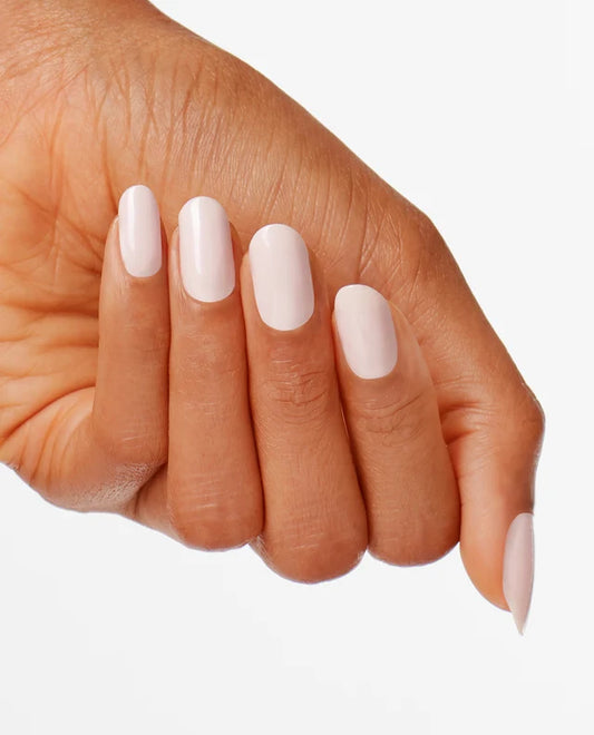 Close-up of a hand with light pink nail polish OPI let me Bayou a Drink a white background
