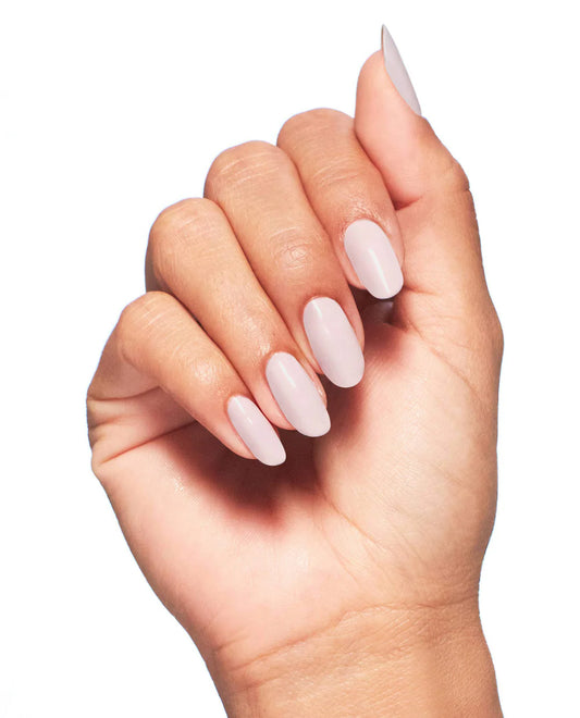 Natural manicure on hands displaying OPI Pink In Bio glossy finish with smooth even application coverage.