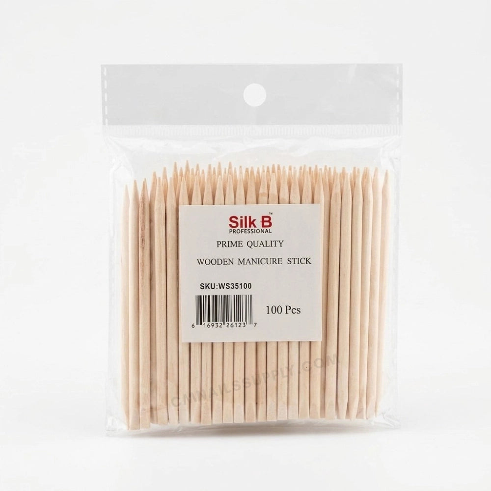 pack of orange wood sticks on white background for salon use manicure and cuticles
