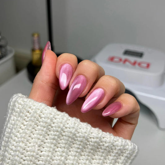 pink cat eye nails on manicured hand wearing DND DIVA #08 Kitty Blossom