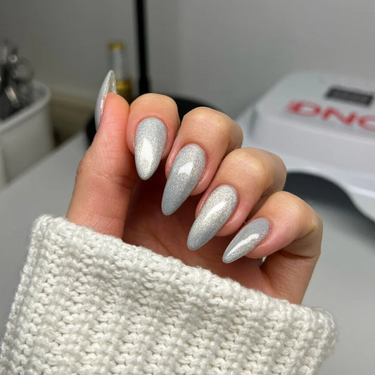 Silver cat eye nails on manicured hand wearing DND DIVA Moonrise 25