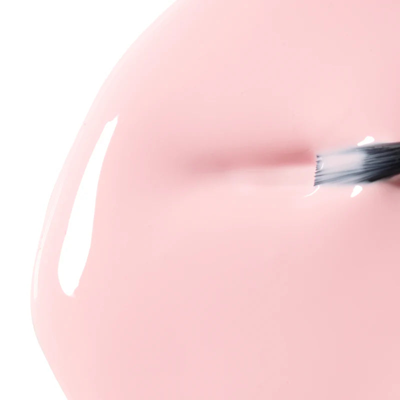 Close-up of a pink 04 Marshmellow | Bio Seaweed Gel - CM Nails & Beauty Supply with a brush on a white background