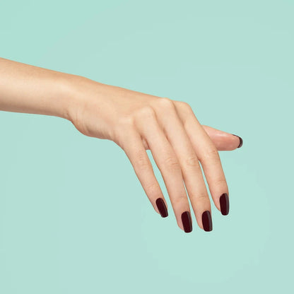 Full manicure in 1041 Escape the City black cherry nail polish on a hand, highlighting the deep red cherry shade on all nails.
