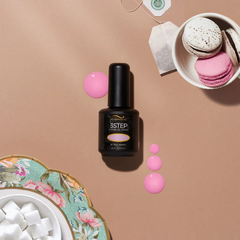 Nail polish bottle tea party with pink polka dots on a beige background