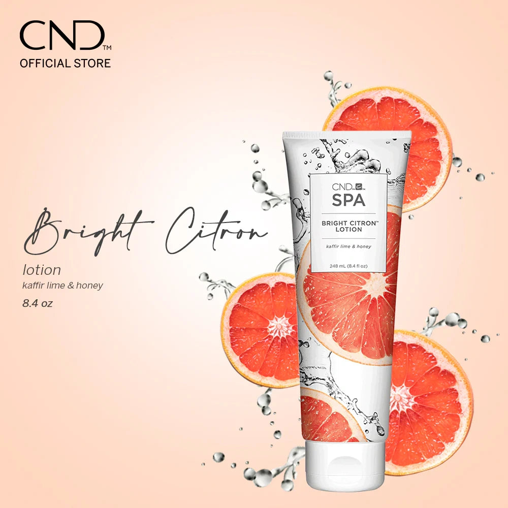 CND Bright Citron lotion tube with grapefruit slices on a light pink background