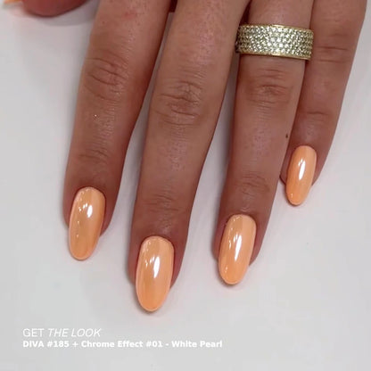Hand with peach-colored nails and a gold ring on a white background