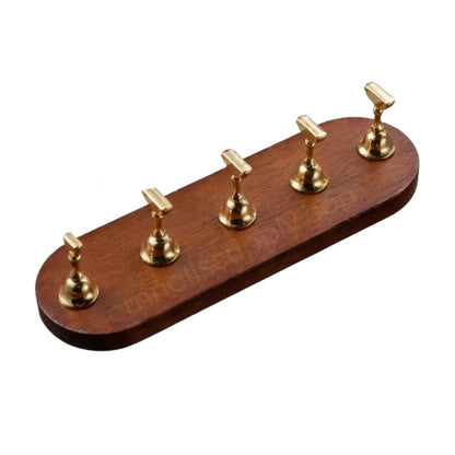 Dark wooden press on base with gold nail stands