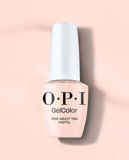 A bottle of OPI GelColor Mod About You Pastel Gel Polish in the shade Mod About You Pastel, featuring a pale peach-pink color and a white cap, set against a matching soft peach-pink background.