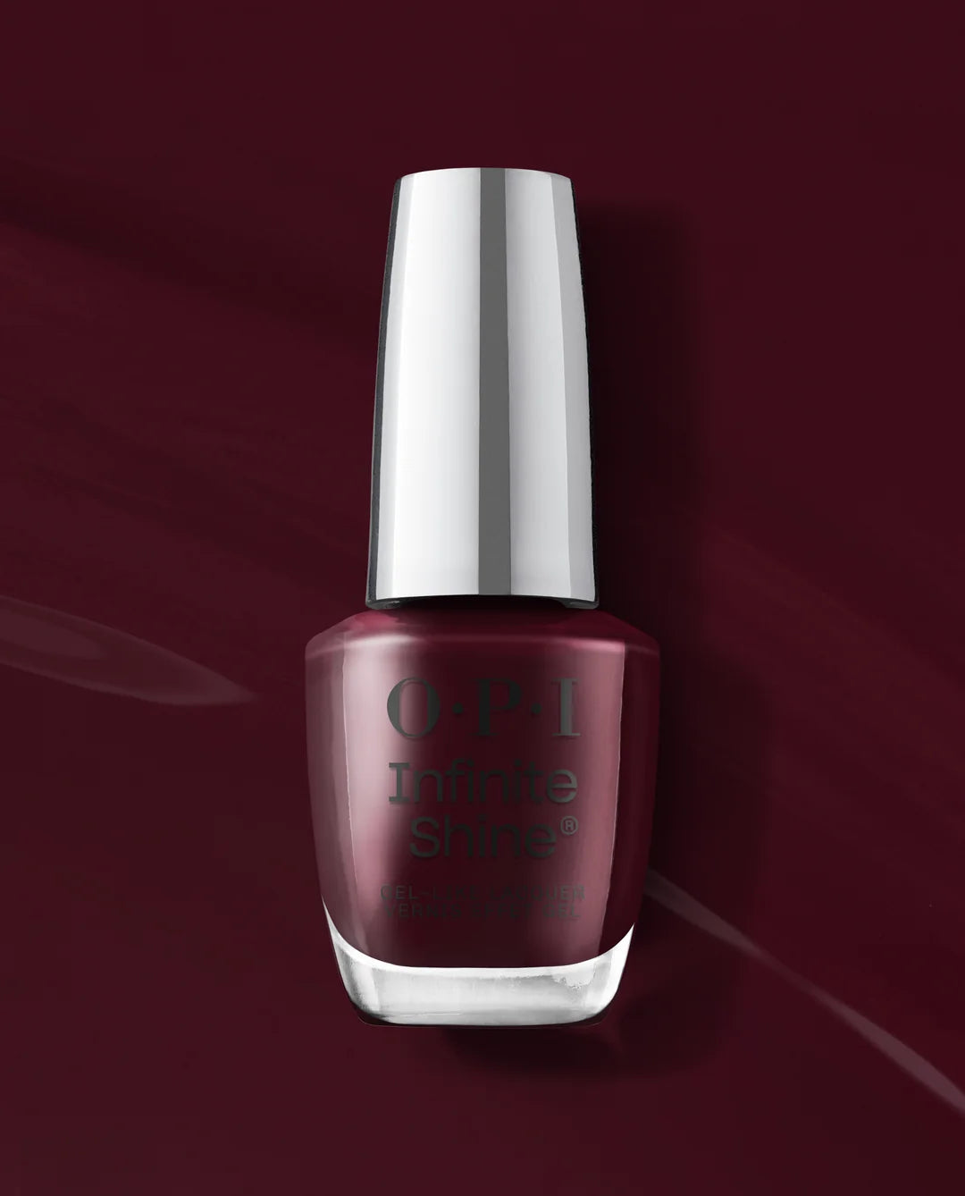 OPI Infinite Shines Mrs. O’ Leary’s BBQ
nail polish in a deep burgundy shade, presented in a classic glass bottle with a reflective silver cap against a matching dark burgundy background.