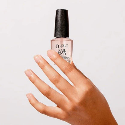 OPI Nail Envy bottle held by a hand on a light gray background