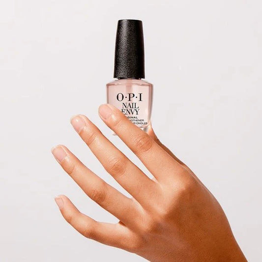 OPI Nail Envy bottle held by a hand on a light gray background