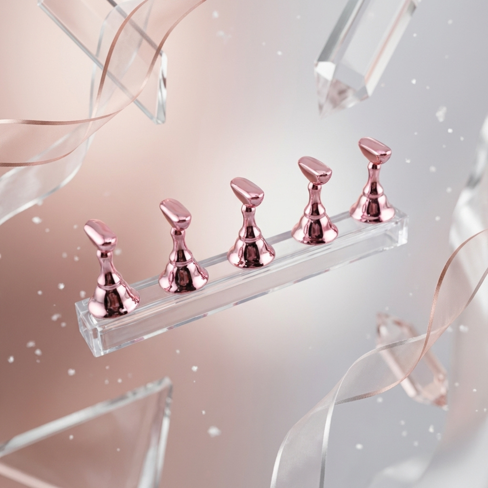Set of rose gold pieces on a clear stand with decorative ribbons and crystals.