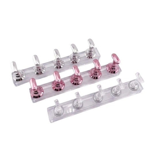 3 clear plastic strips with metal hooks, one pink  one clear and one silver, on a white background.