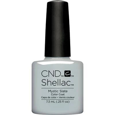 A bottle of CND Shellac nail polish color coat in the shade Mystic Slate, featuring a white bottle and a black cap on a plain white background.