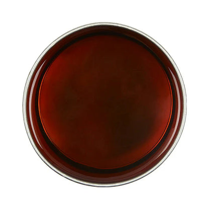 Round brown object with a metallic rim on a white background