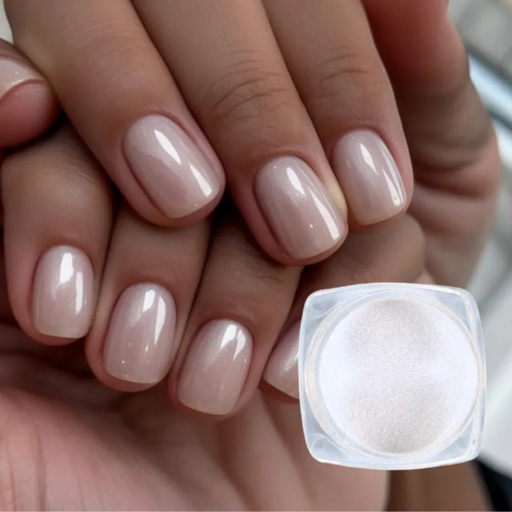 Close-up of hands with nude nail polish and a container of nail  chrome powder
