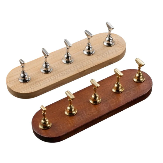 Two wooden press on stands - one light wooden with silver stands, one dark wooden with gold stands