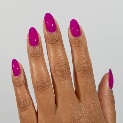 Manicured hand wearing DC Jelly 018 Amethyst jelly gel polish to show the royal purple glow with a pink undertone in natural light