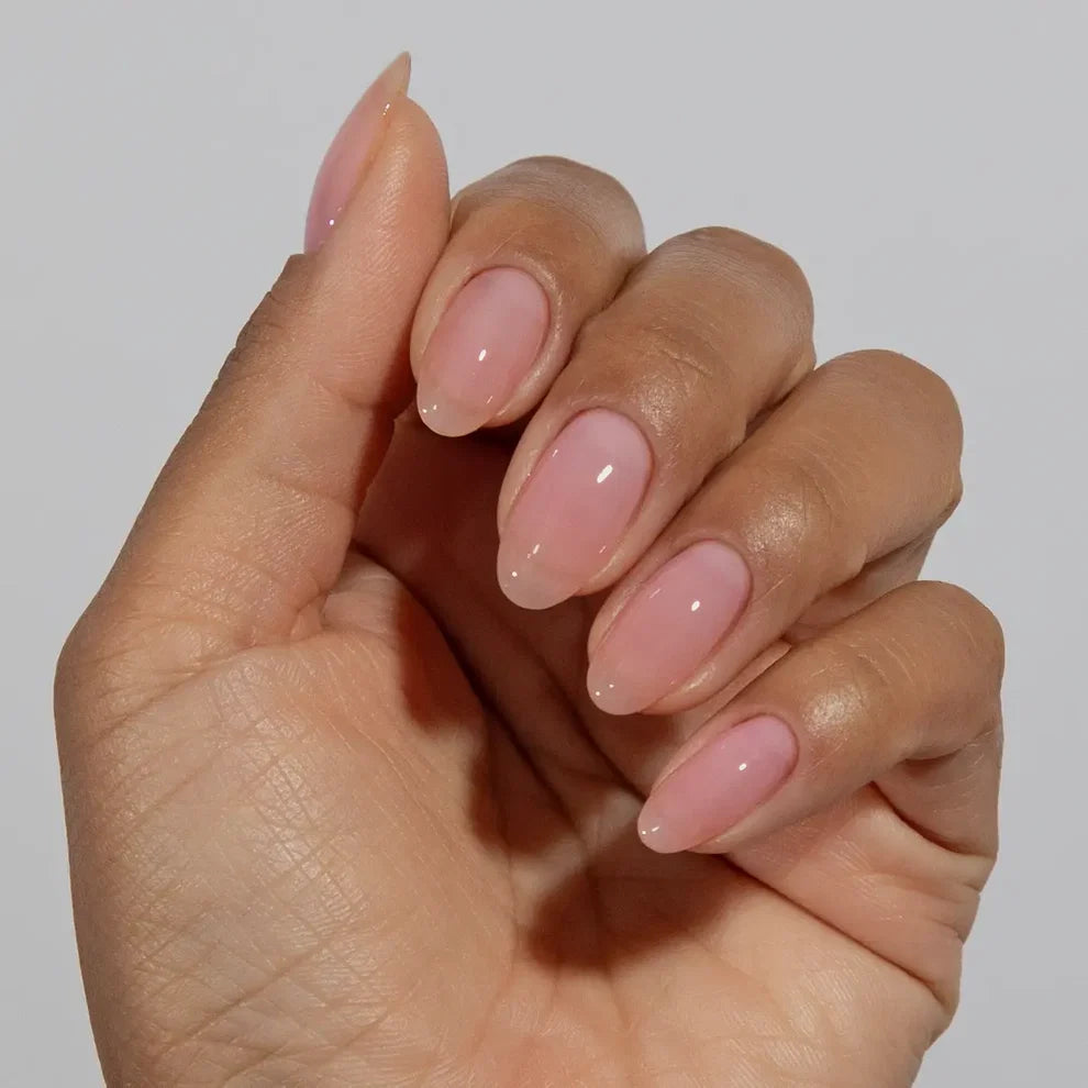 Manicured hand wearing DC Jelly 09 Blush jelly gel polish to show the soft pink finish in natural light