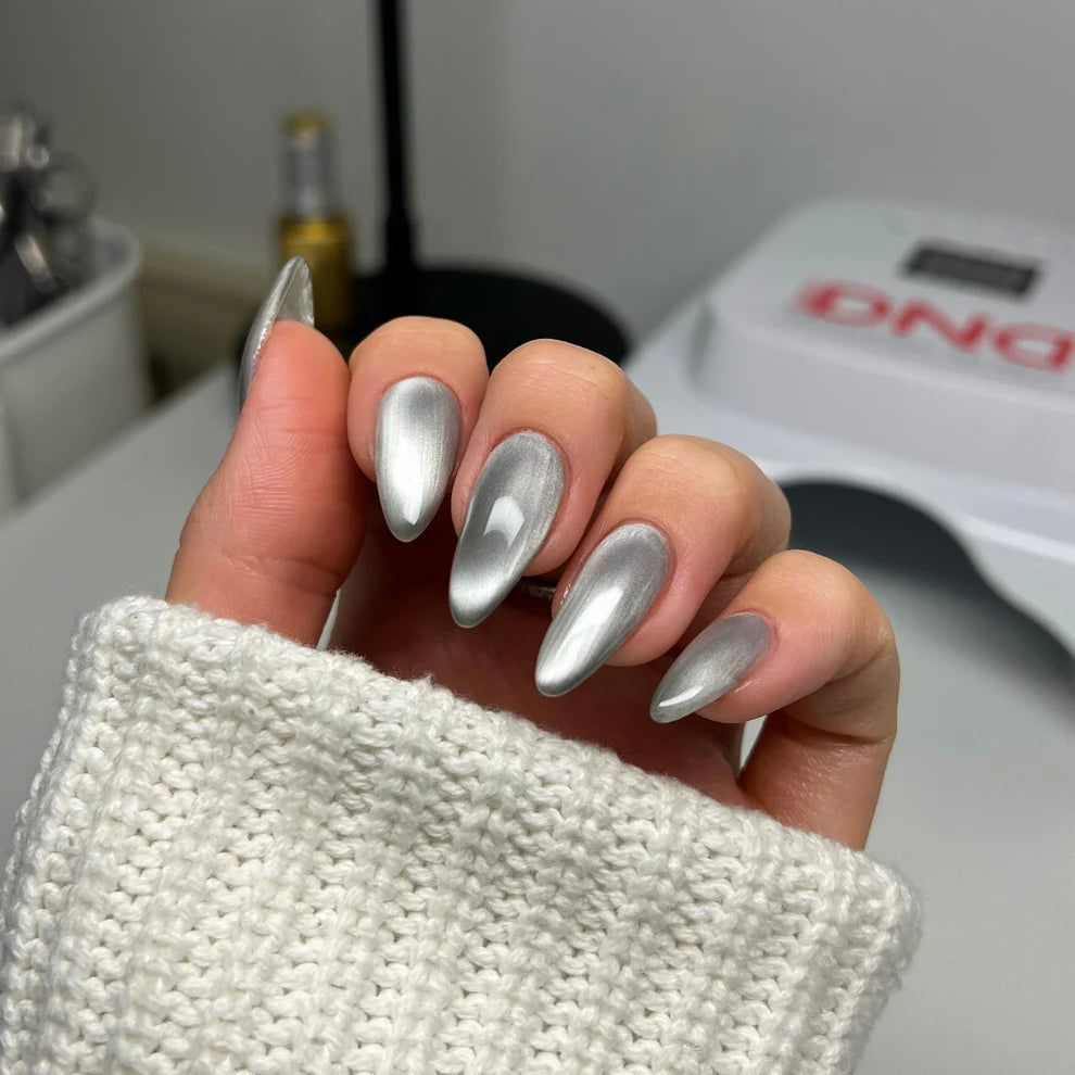 Cat eye nail polish gel application showing Mirror-acle silver metallic shimmer and magnetic particles