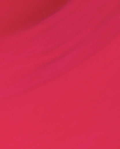 A close-up of a solid, vibrant magenta pink fabric texture with soft, diagonal folds.