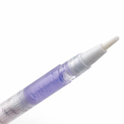 Close up of cuticle nail pen oil pen for nourishing and protecting dry nail beds.