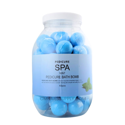 Mint pedicure bath bomb dissolving in a warm water foot soak