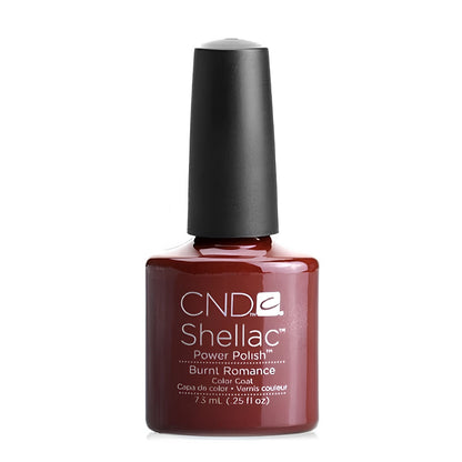 CND Shellac Burnt Romance nail polish bottle standing upright, showing the deep red maroon shade with terracotta undertones.