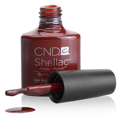 Close up color swatch of CND Shellac Burnt Romance showing the warm red maroon shade with brick red and terracotta undertones.
