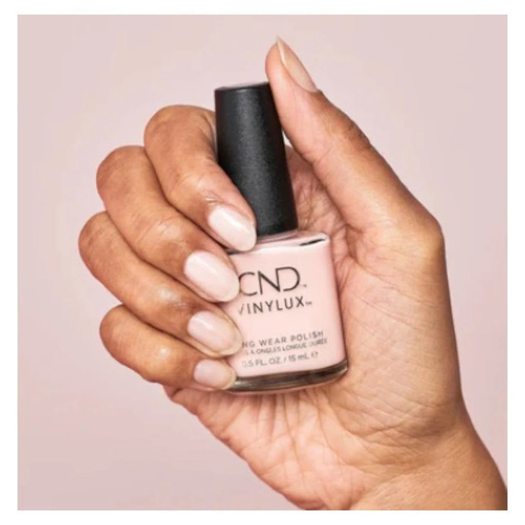 CND VINYLUX Bouquet #319 nail polish bottle in a soft, translucent milky pink shade.