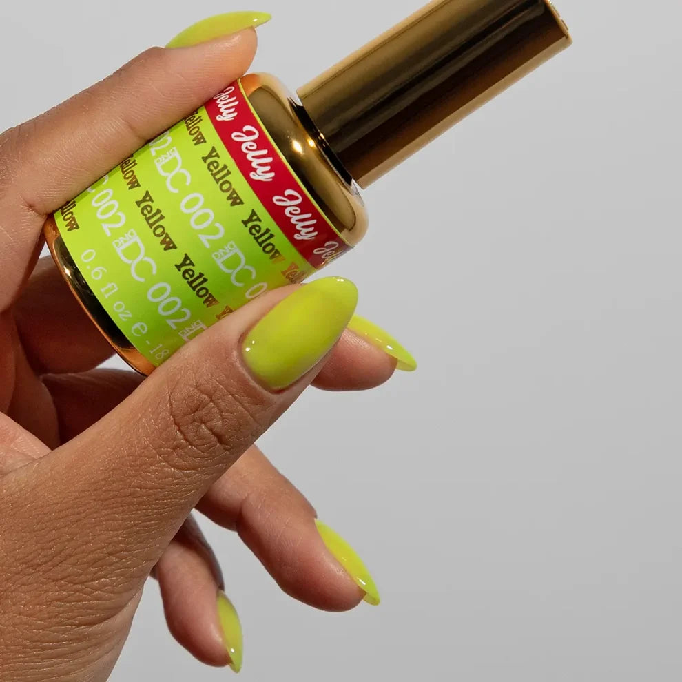 Close-up manicure showing DC Jelly #02 Yellow jelly nail polish with a bright fluorescent finish.