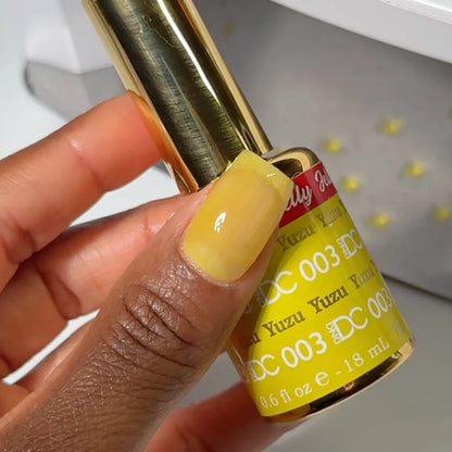manicure hand Close-up manicure showing DC Jelly #03 Yuzu jelly nail polish with a lemon yellow finish.