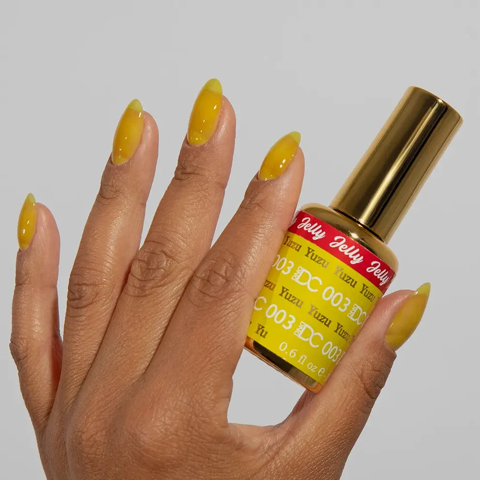 Close-up manicure showing DC Jelly #03 Yuzu jelly nail polish with a lemon yellow finish.