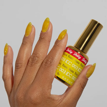 Close-up manicure showing DC Jelly #03 Yuzu jelly nail polish with a lemon yellow finish.