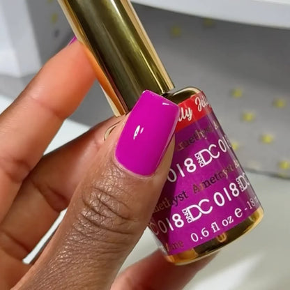 Deep skin tone manicured hand showing DC Jelly 018 Amethyst jelly gel polish with a royal purple creamy glow