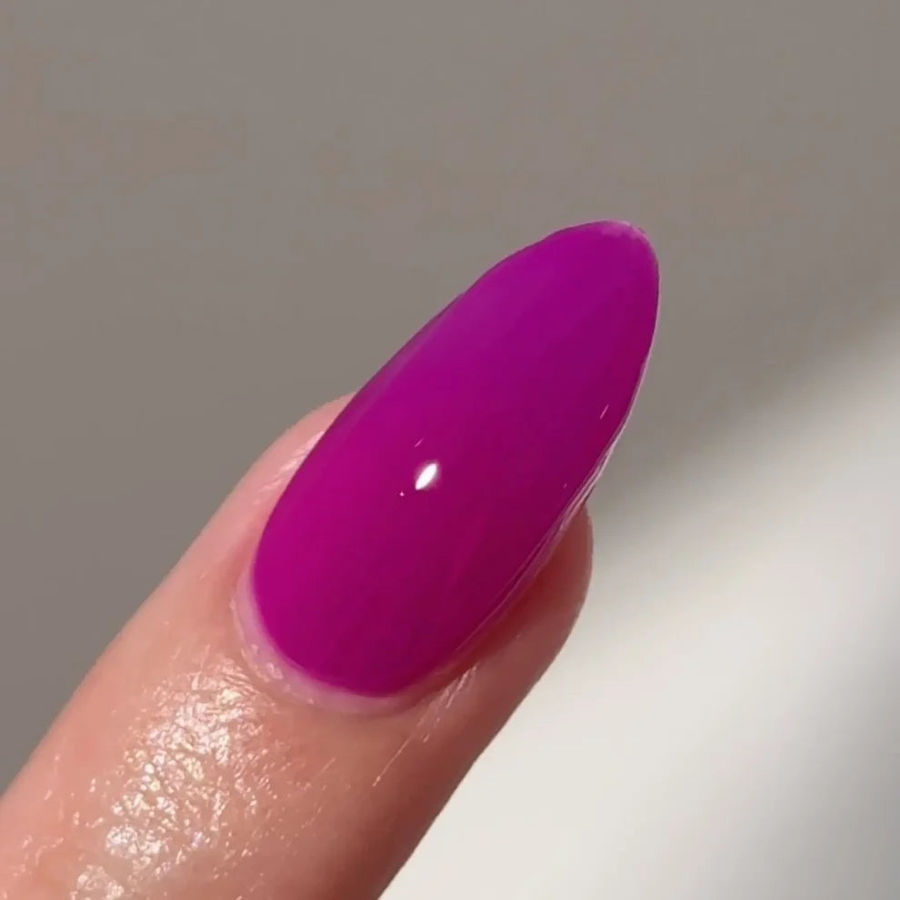 Manicured hand with DC Jelly 018 Amethyst jelly gel polish applied to show the finished salon style manicure