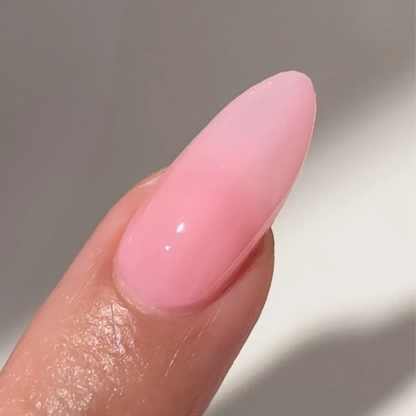 Manicured hand with DC Jelly 09 Blush jelly gel polish applied to show the finished salon style manicure
