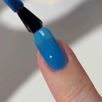 Manicured hand with DC Jelly 023 Capri jelly gel polish applied to show the finished salon style manicure