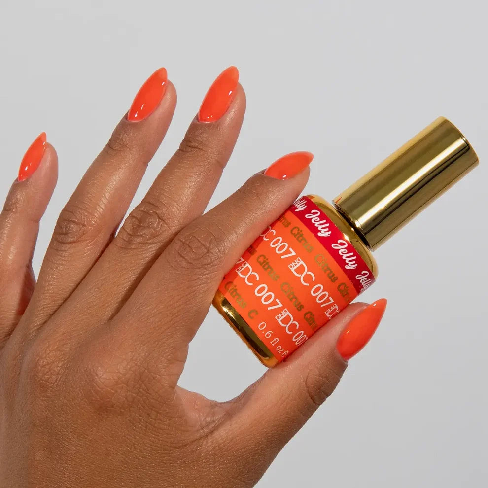 Manicured hand with DC Jelly 07 Citrus jelly gel polish applied to show the finished salon style manicure