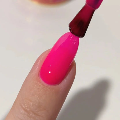 Manicured hand with DC Jelly 011 Hot Pink jelly gel polish applied to show the finished salon style manicure