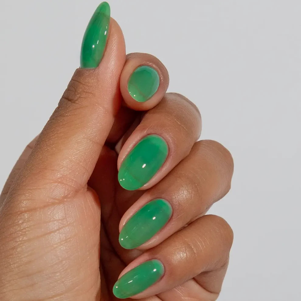 Manicured hand wearing DC Jelly 05 Kelly jelly gel polish to show the finished salon style application