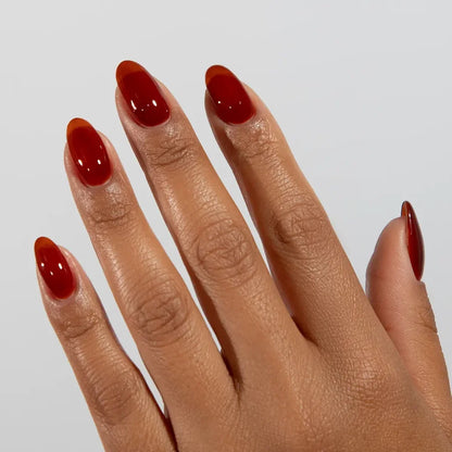 DC jelly gel polish on a manicured hand for Amber 028 showing the warm honey glow in natural light