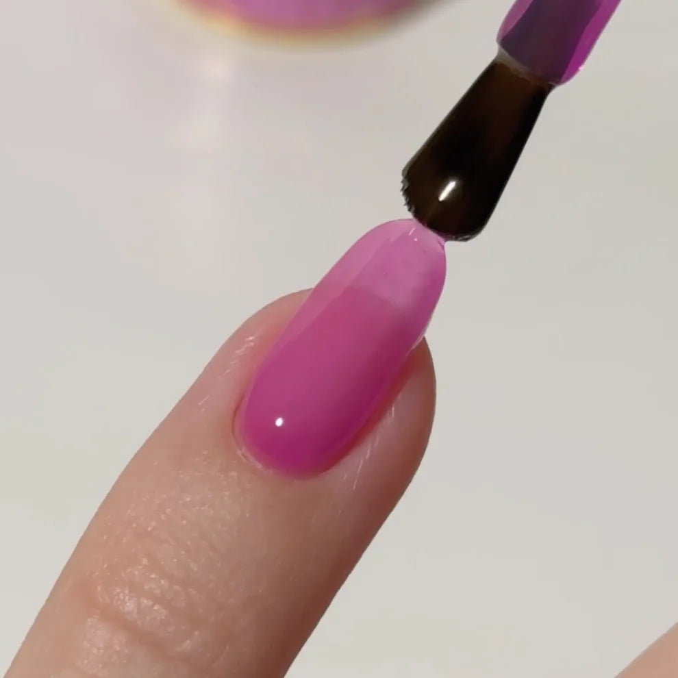 Manicured hand with DC Jelly 017 Orchid jelly gel polish applied to show the finished salon style manicure