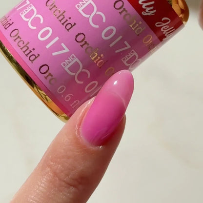 Manicured hand with DC Jelly 017 Orchid jelly gel polish applied to show the finished salon style manicure