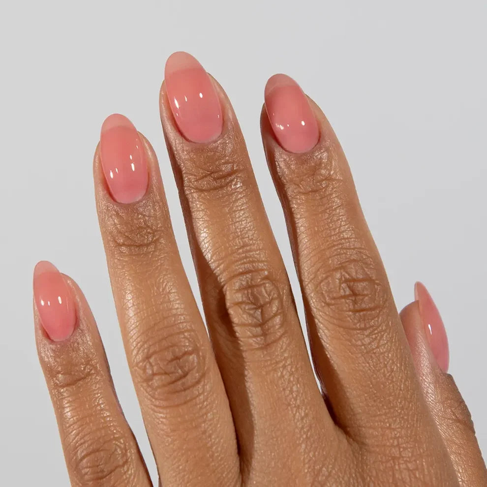 Manicured hand with DC Jelly 016 Rose jelly gel polish applied to show the finished salon style manicure