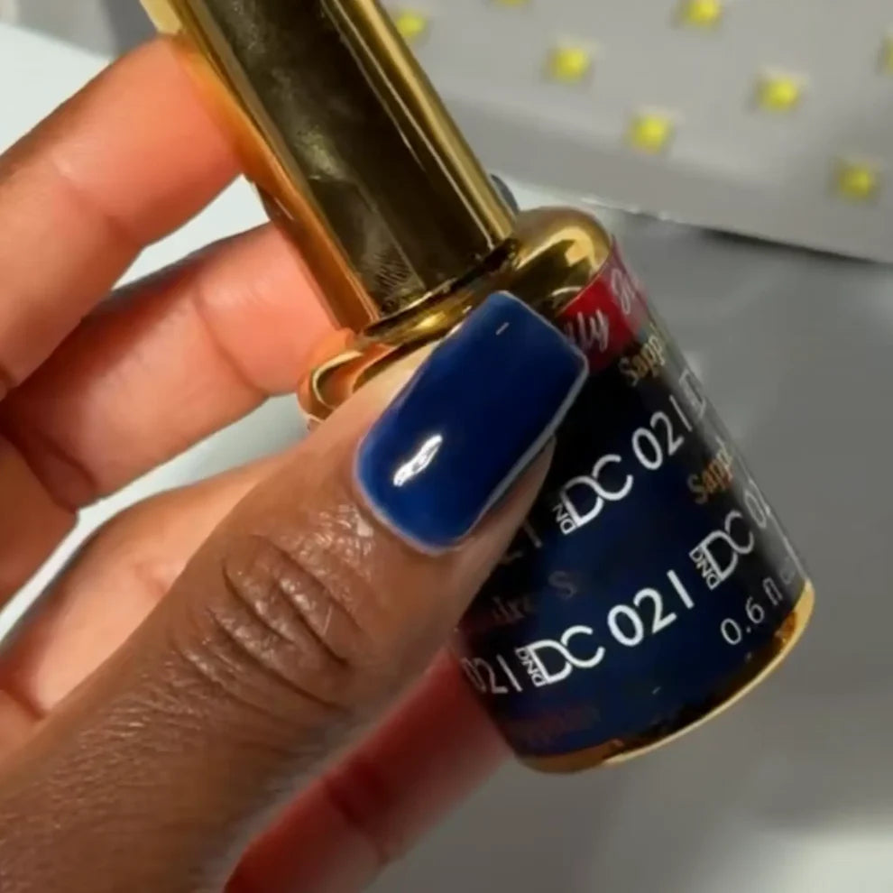 Manicured hand with DC Jelly 021 Sapphire jelly gel polish applied to show the finished salon style manicure