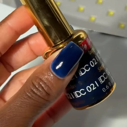 Manicured hand with DC Jelly 021 Sapphire jelly gel polish applied to show the finished salon style manicure