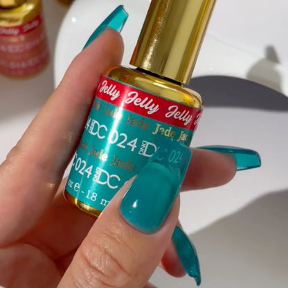 Fair skin manicured hand showing DC Jelly 024 Jade jelly gel polish with a crystal clear turquoise glow